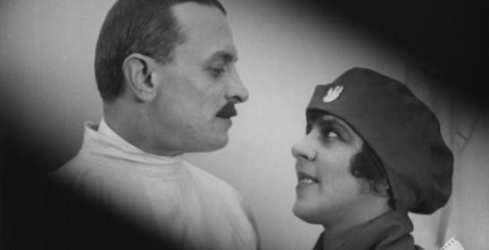 portrait of a woman in a beret and a man with a mustache looking at each other