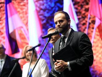 Man in suit on stage