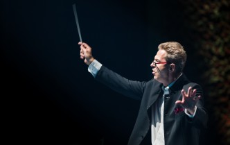 conductor with hands raised