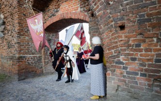 Costumed people holding flags