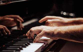 Fingers pressing piano keys