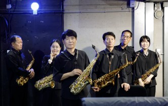 grupa osób trzymających saksofony