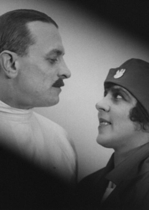 portrait of a woman in a beret and a man with a mustache looking at each other