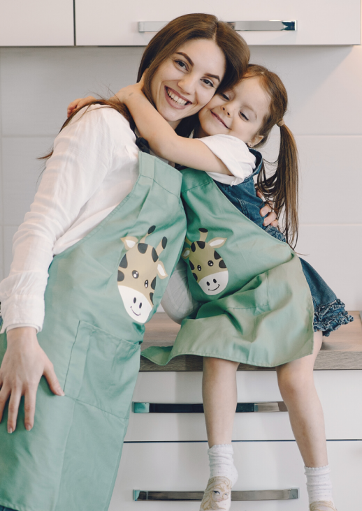 standing woman hugging a child sitting on the counter