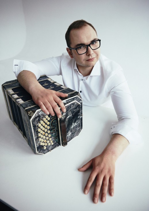 a man leaning on a bandoneon