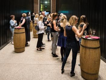 Bankiet, Finał XXI Międzynarodowego Festiwalu Nova Muzyka i Architektura bankiet po koncercie, Kontrahenci elegancko ubrani stoją przy wysokich beczkach służących jako wysokie stoły