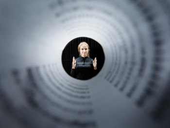 photo. Łukasz Ułanowski view of a woman holding a baton through a roll of paper